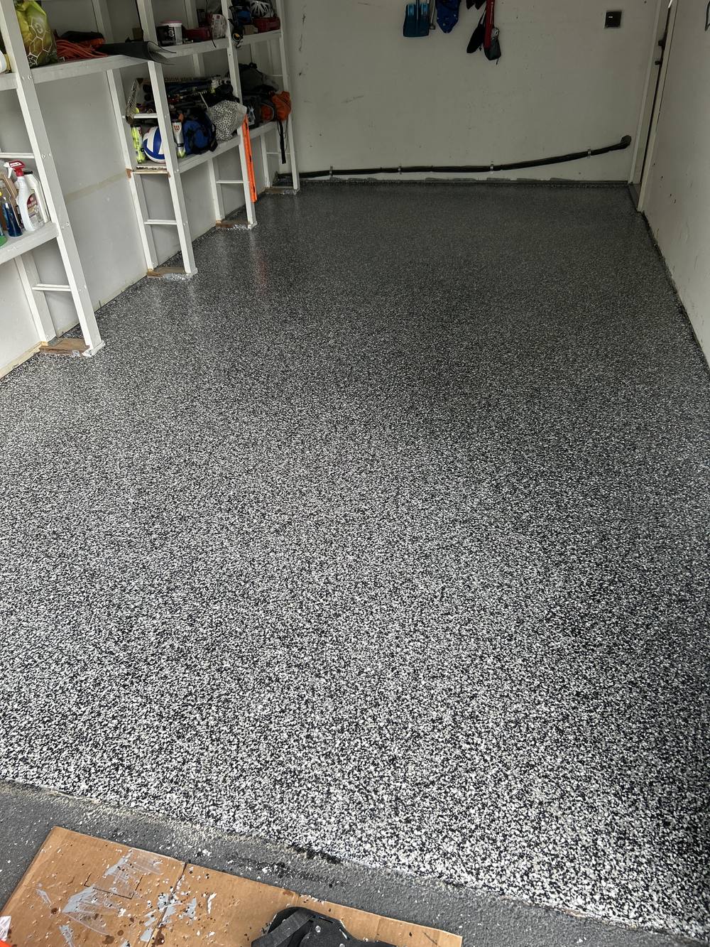 Garage floor after coating, grey and black flake finish