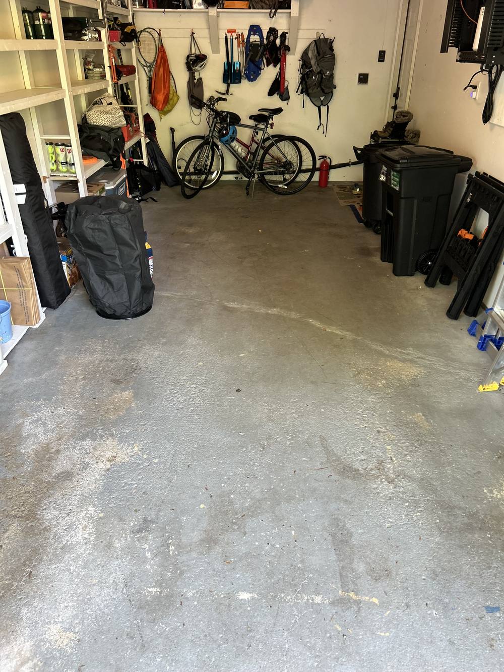 Garage floor before coating, bare stained concrete