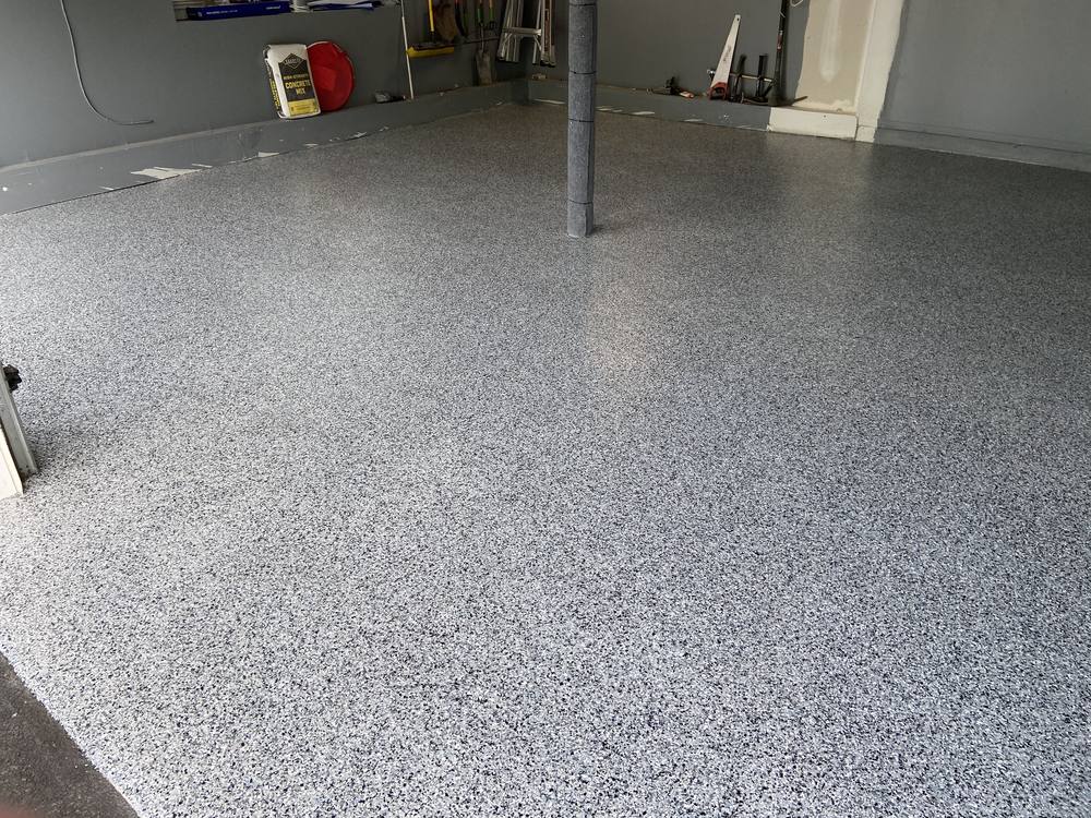 Garage floor after coating, grey and white flake finish