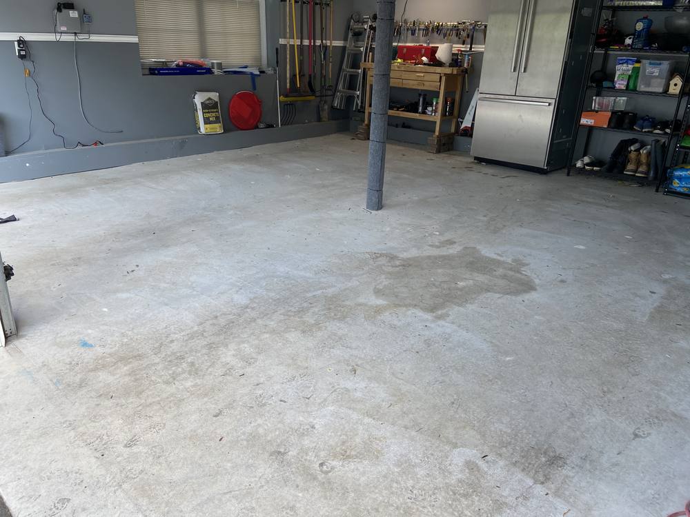 Garage floor before coating, bare concrete with stains